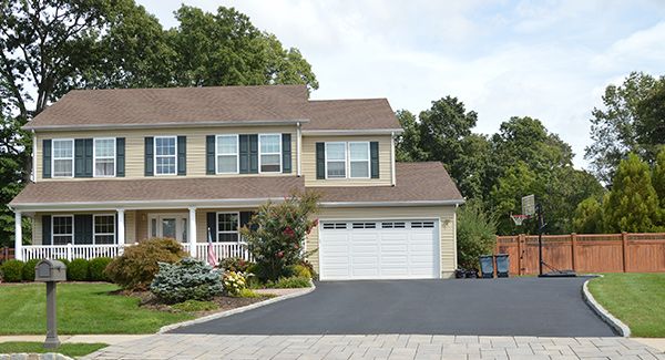 Photo of house with paved driveway